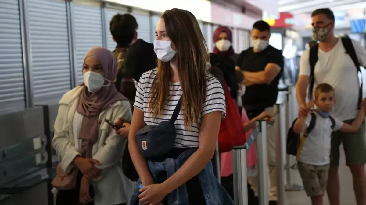 Newly-arrived passengers from California and Turkey wait to be tested for coronavirus (COVID-19) at Tegel (TXL) airport on July 29, 2020 in Berlin