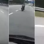 Ein seltsamer Motorradfahrer auf einer Straße in Malaysia