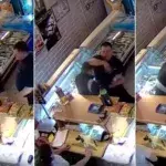 Security in Russland beherrscht einen bewaffneten Dieb, der eine Verkäuferin angreift