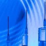 Vaccine research concept: three syringes in a modern laboratory context with curved blue lines