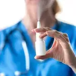 Frau hält Nasenspray