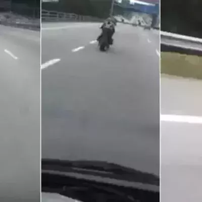 Ein seltsamer Motorradfahrer auf einer Straße in Malaysia