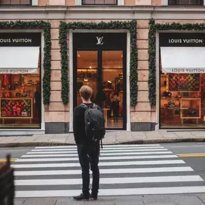 Ein Mann steht vor einer Louis Vuitton-Boutique