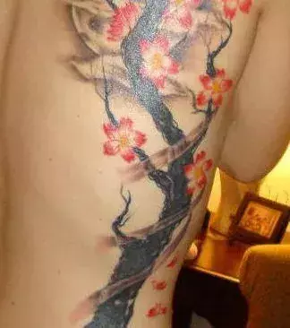 Auf den Rippen eines Mannes: ein Baum Tattoo