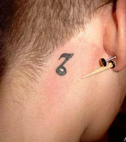Noten Tattoo hinter dem Ohr eines Mannes